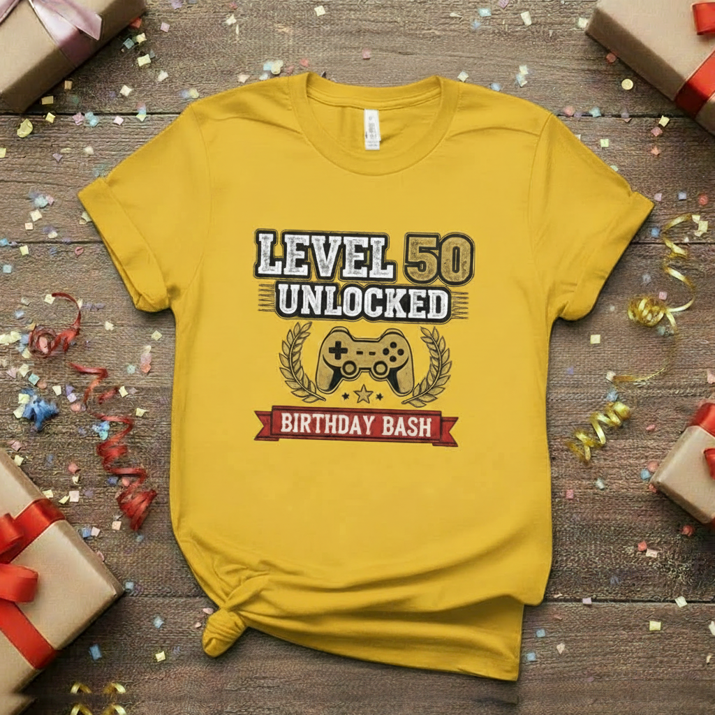 Yellow t-shirt with 'Level 50 Unlocked Birthday Bash' design on a wooden surface with gifts and confetti.